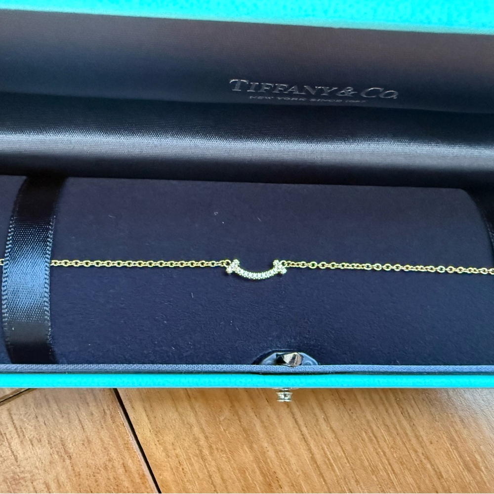Tiffany and co  T Smile Bracelet in Rose Gold with Diamonds. 

Size small.